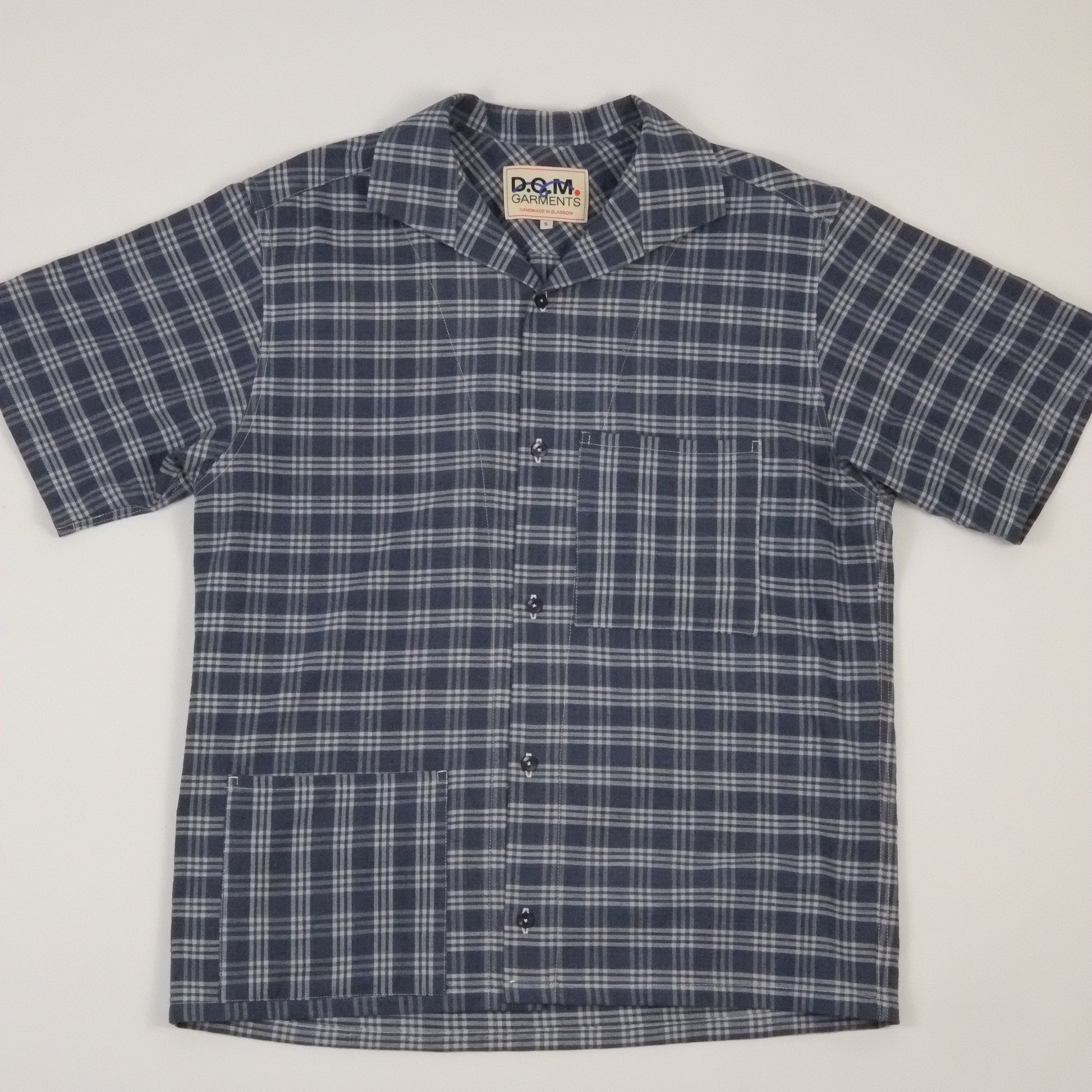 Blue and white checkered shirt on a light gray background