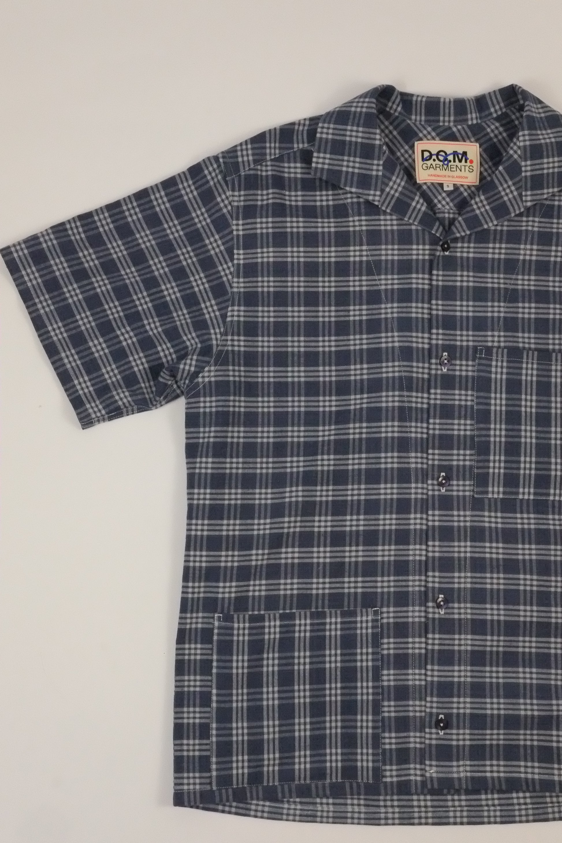 Plaid shirt with a brand label on a light background