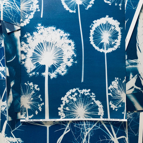 Wallpaper with white dandelion designs on a blue background