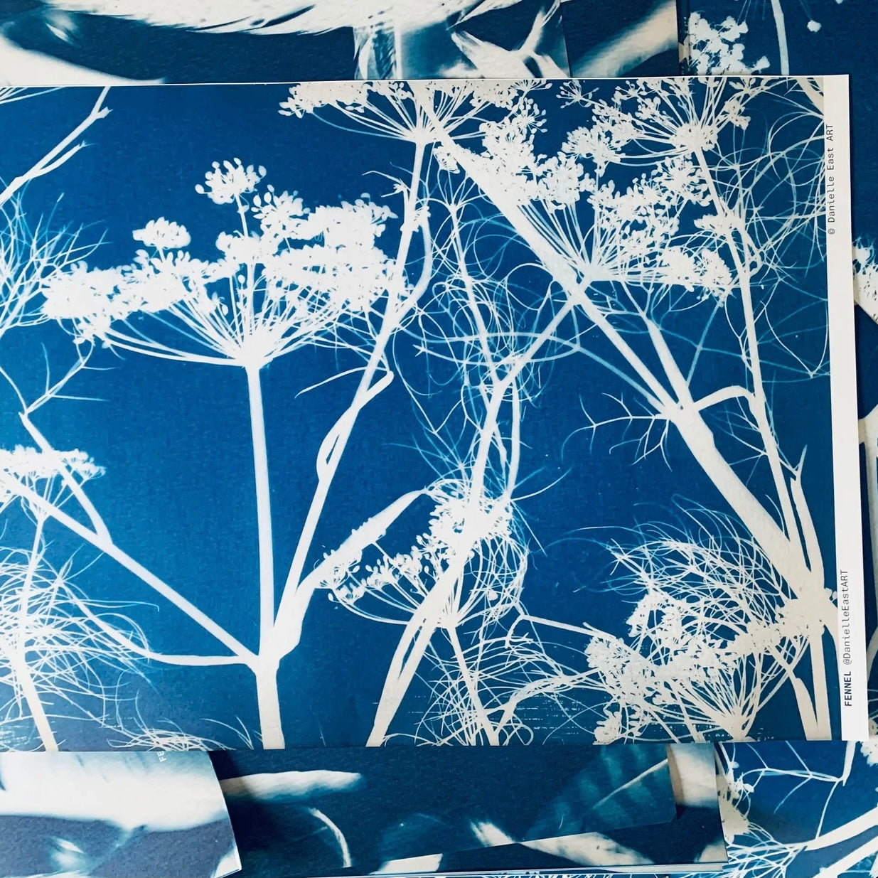 Blue fabric with white floral pattern, displayed on a flat surface.