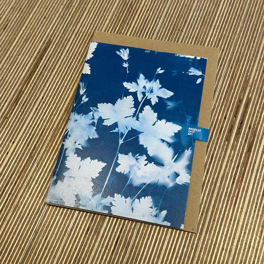 a card with white and blue foliage on the front