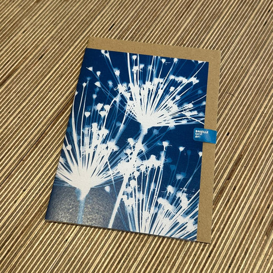 Greeting card with dandelion design on a textured surface
