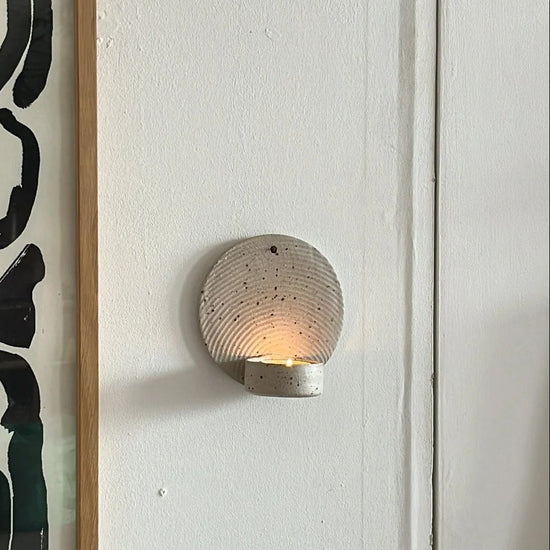 Wall sconce with abstract art on a white wall