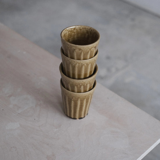 Stack of ceramic cups on a concrete surface