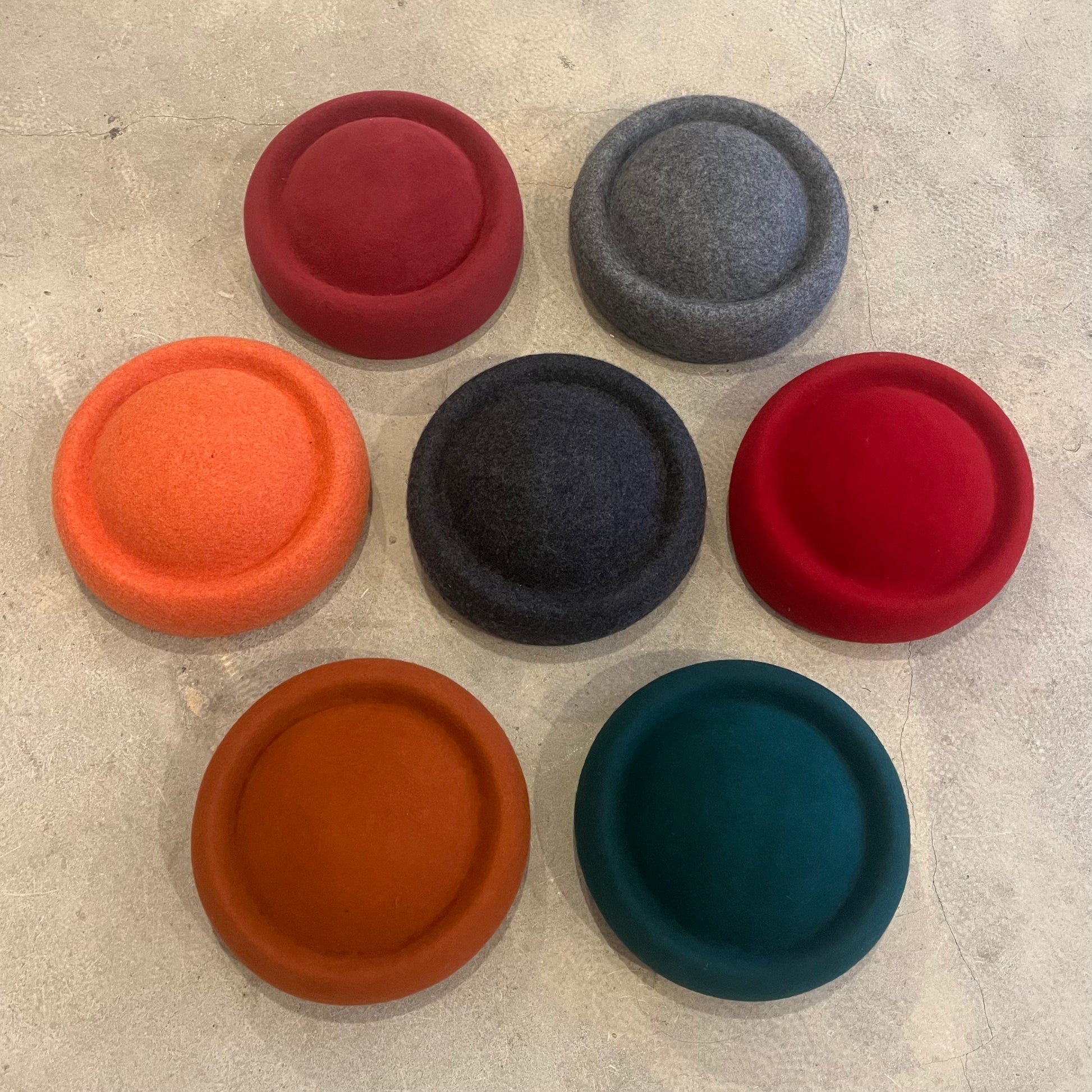 new york style berets on a grey background