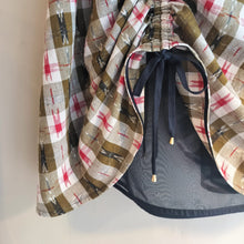 Load image into Gallery viewer, Plaid-patterned garment with a drawstring on a neutral background
