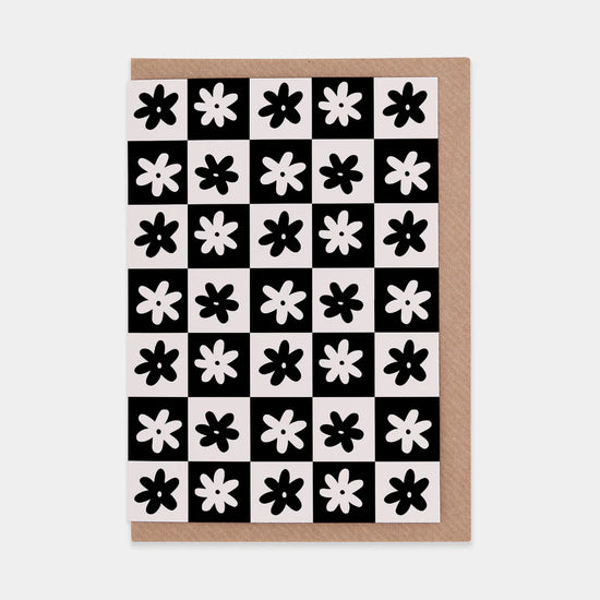 Monochrome checkerboard card with simple flower design and brown envelope 