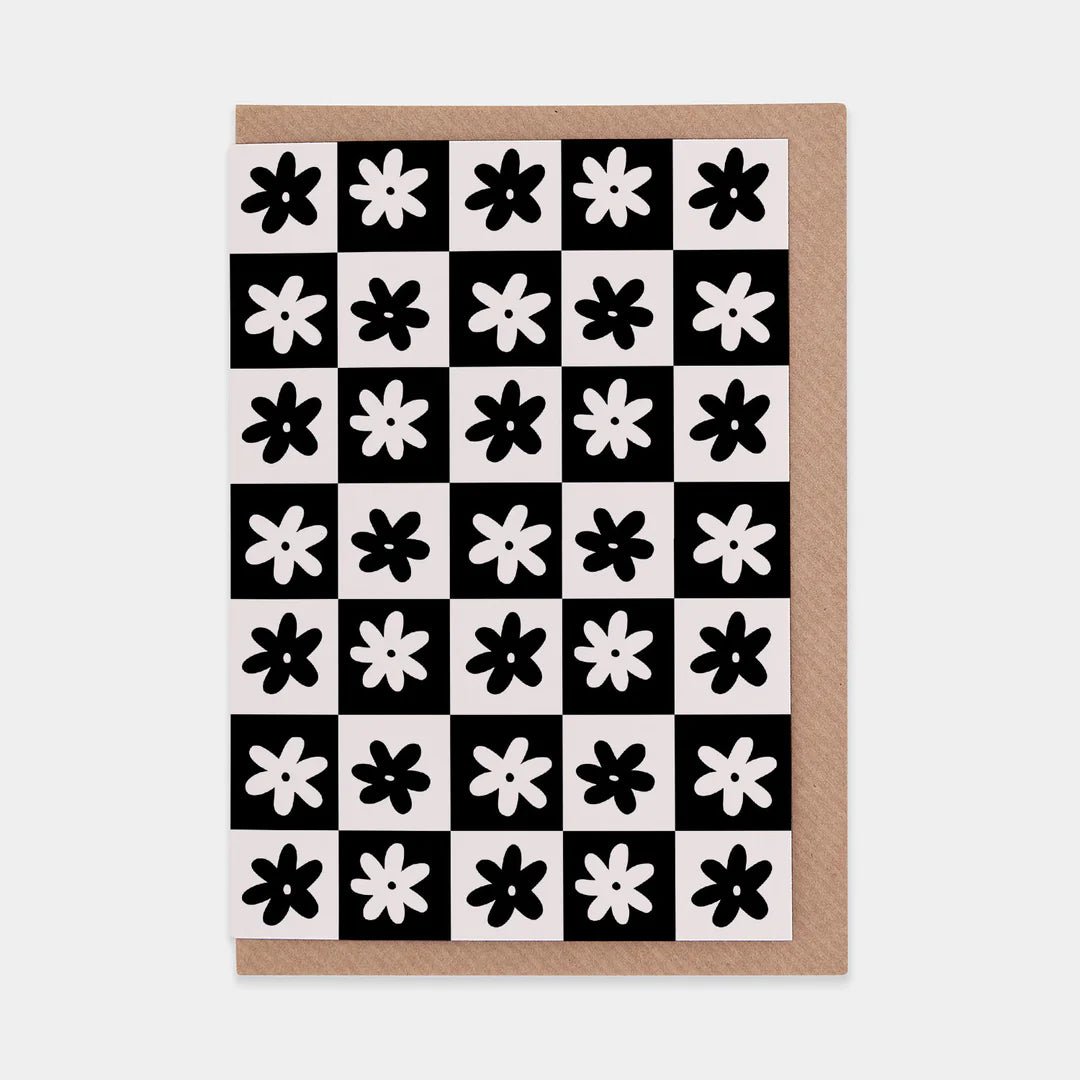 Monochrome checkerboard card with simple flower design and brown envelope 