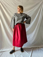Load image into Gallery viewer, Person wearing a checkered black and white top and red skirt against a plain background

