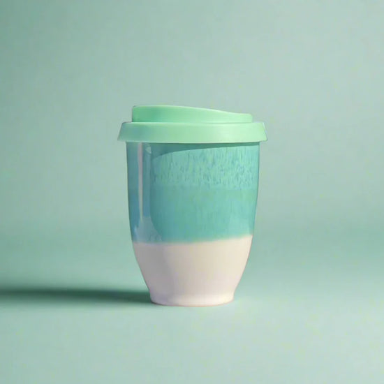 Two-toned mug with a green top and white bottom on a light green background