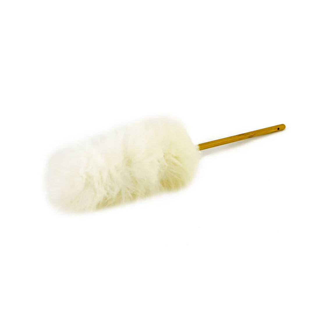 White lambswool duster with a wooden handle on a white background