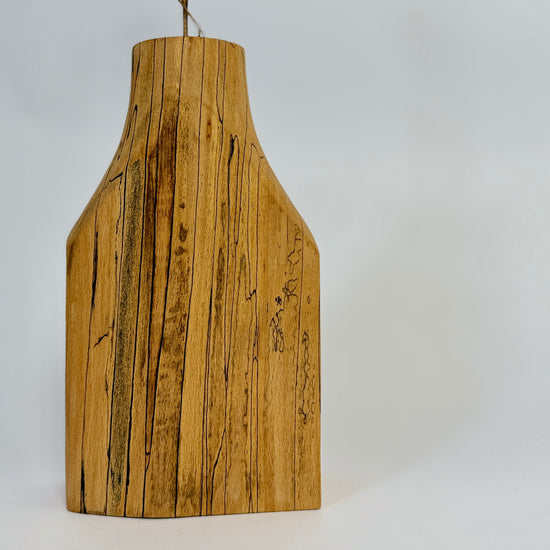 Wooden vase with a natural finish on a light grey background