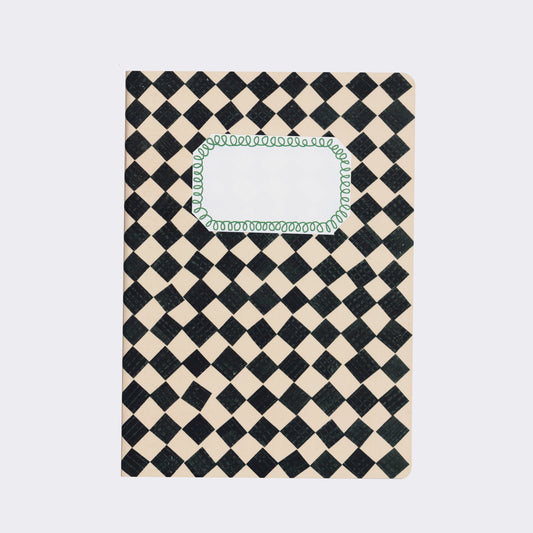 A black and white checkered sketchbook with a clear label window on the cover.