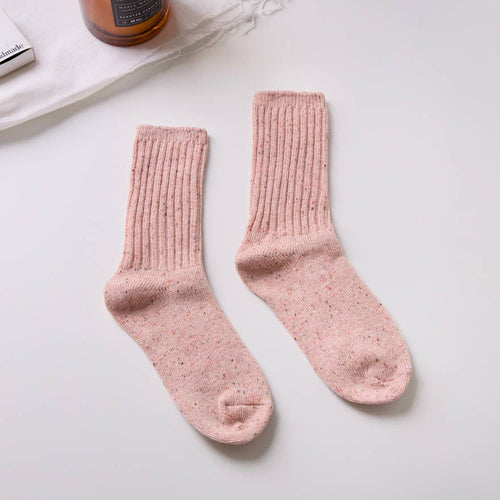 Pair of pink socks on a light gray background