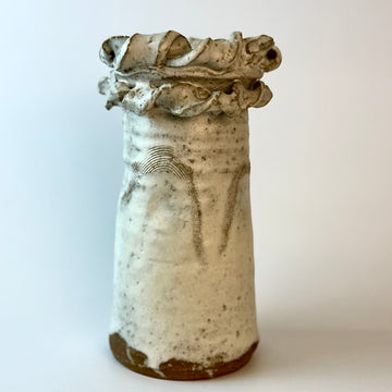 Ceramic vase with textured surface on a white background