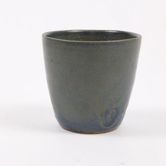 Dark gray ceramic cup on a white background