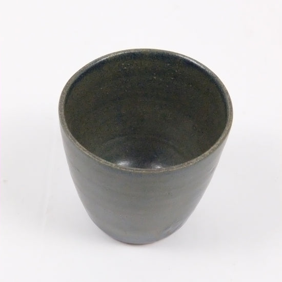 Black ceramic cup on a white background