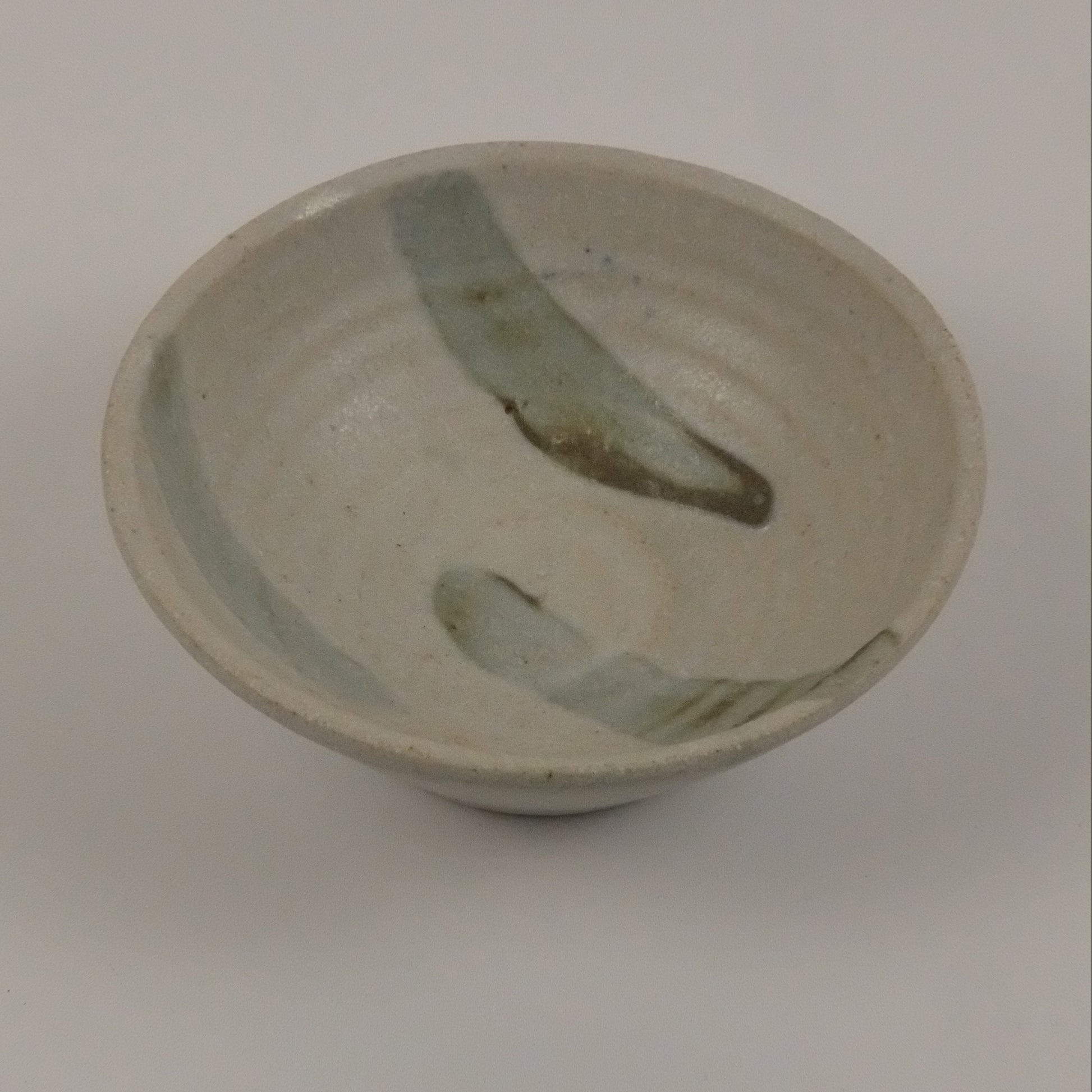 A small striped beige bowl on a white background 
