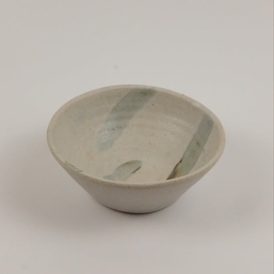 Ceramic bowl with green accents on a white background