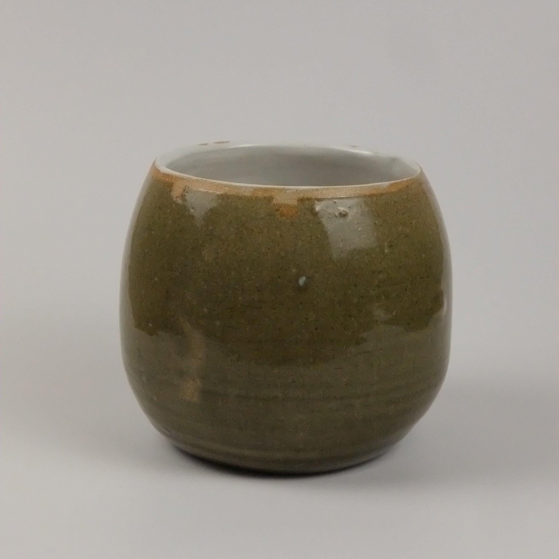 A green vase on a white background 