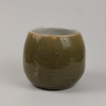 A green vase on a white background 