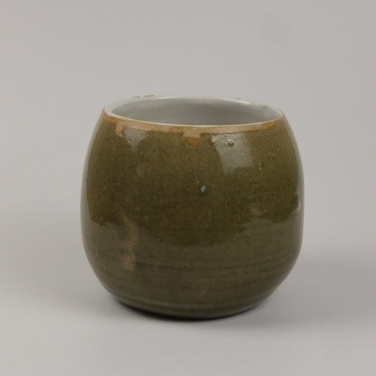 A green vase on a white background 