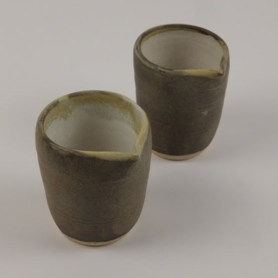 Two cylindrical objects on a plain background