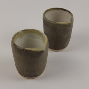 Two cylindrical objects on a plain background