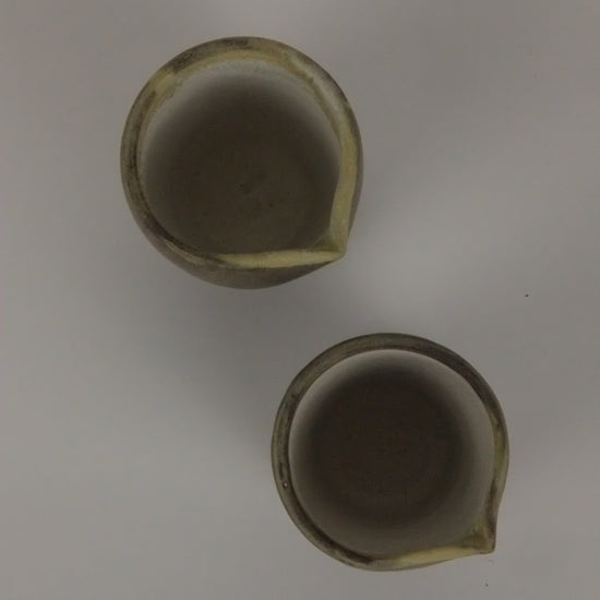 Two ceramic pots on a white background