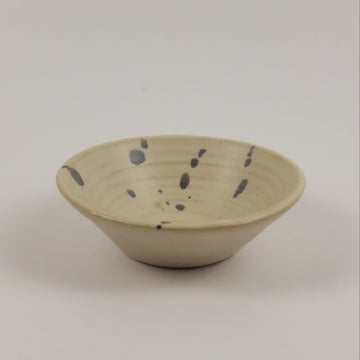 Ceramic wall hook with speckled design on a plain background