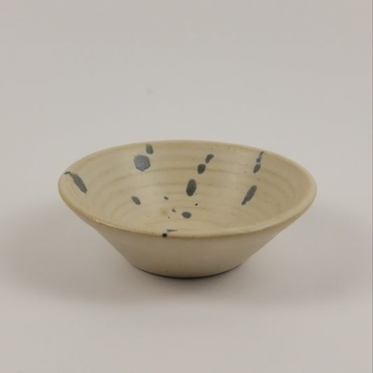 Ceramic wall hook with speckled design on a plain background