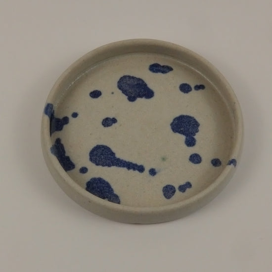 Ceramic plate with blue abstract design on a white background