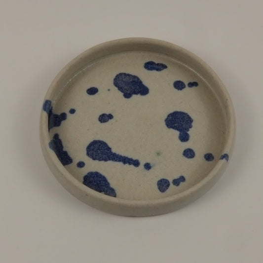 Ceramic plate with blue abstract design on a white background