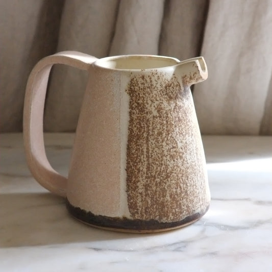 a ceramic jug on a marble table 
