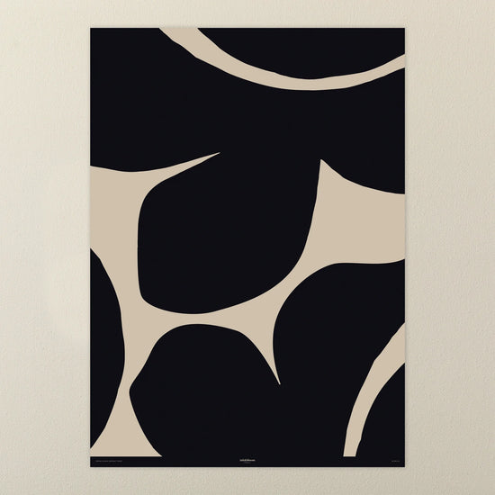 Abstract gift wrap with black and beige shapes on a beige background