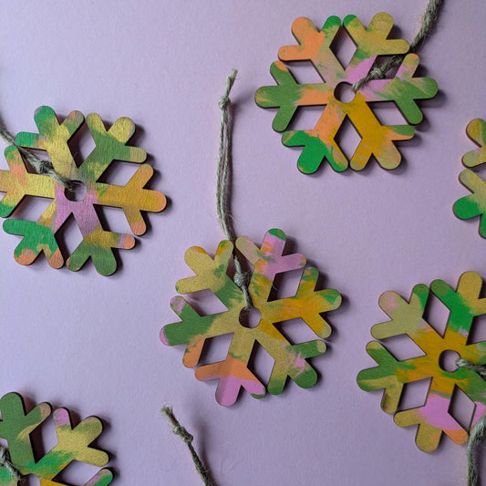 Colourful snowflake decorations on a purple background.