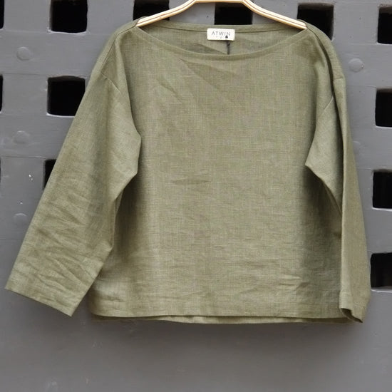 Green shirt on a gray grid background
