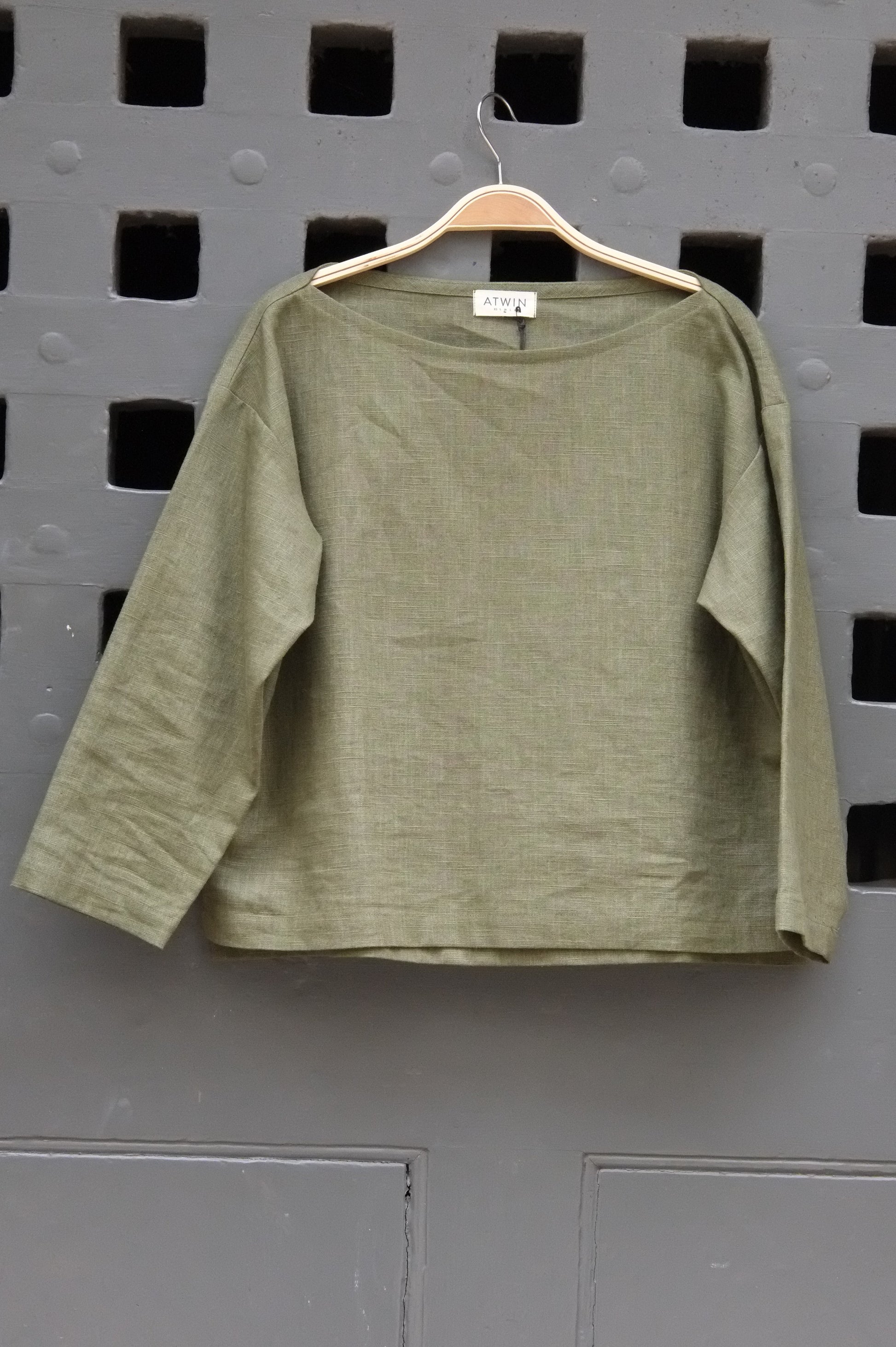 Green shirt on a gray grid background