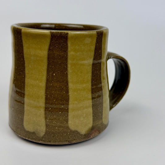 Brown and green striped ceramic mug on a white background