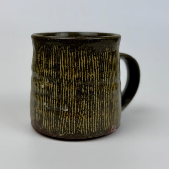 Ceramic mug with textured design on a white background