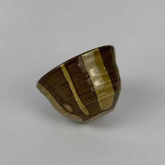 Striped ceramic bowl on a gray background