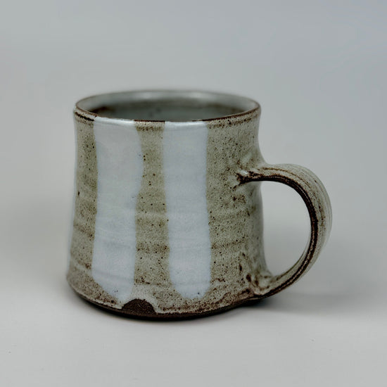 Ceramic mug with a textured surface on a plain background