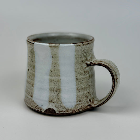 Ceramic mug with a textured surface on a plain background
