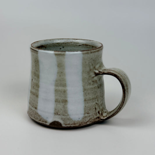 Ceramic mug with a textured surface on a plain background
