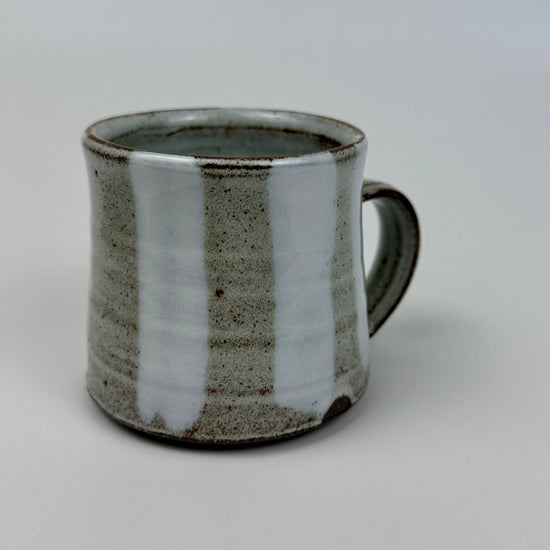 Ceramic mug with a textured surface on a plain background