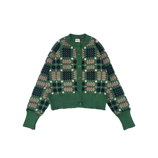 A green knit cardigan sweater with a geometric pattern in dark green, beige, and white, featuring a button-up front and ribbed cuffs and hem.