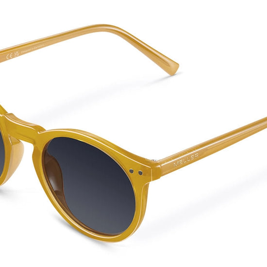 Yellow sunglasses with dark lenses on a white background