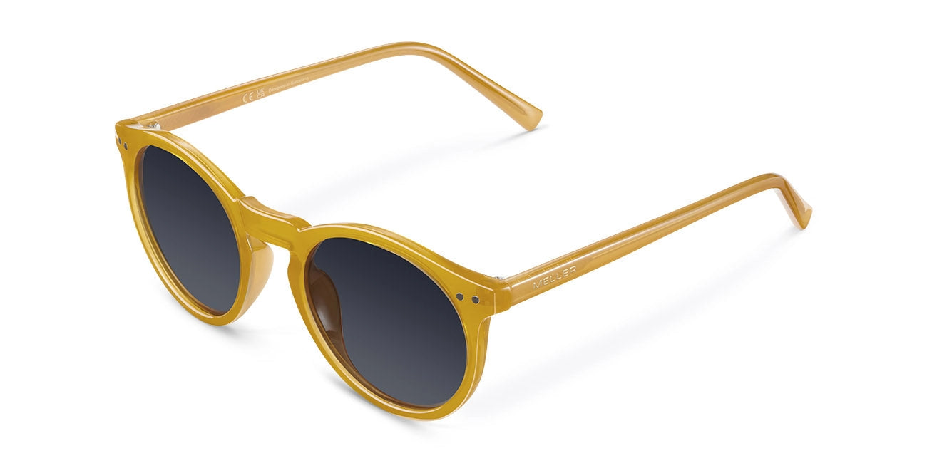 Yellow sunglasses with dark lenses on a white background