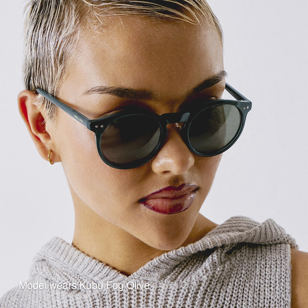 Person wearing dark sunglasses with a neutral background