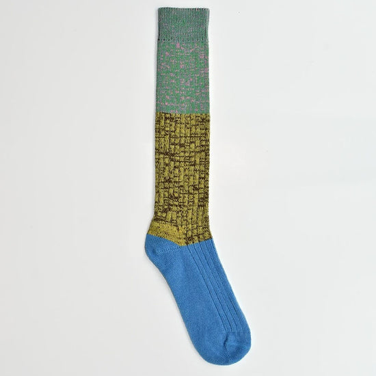Color-blocked sock with green, yellow, and blue sections on a white background